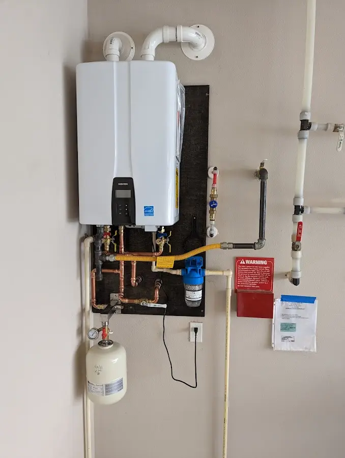 Professional plumber installing copper piping in a Central Park home